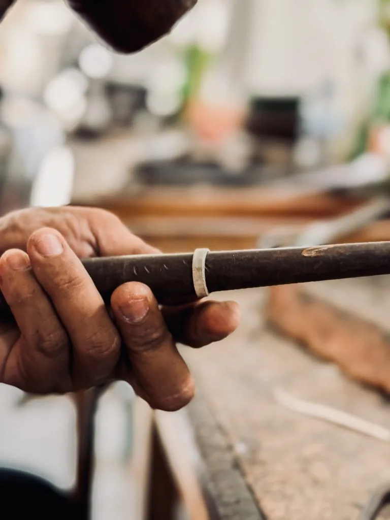 Guest shaping a silver ring at a bench during a silver class in Sanur, Bali