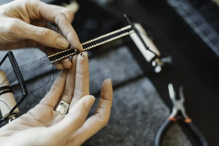 Student filing a sterling silver ring at the Bintang Sanur Jewelry Workshop bench